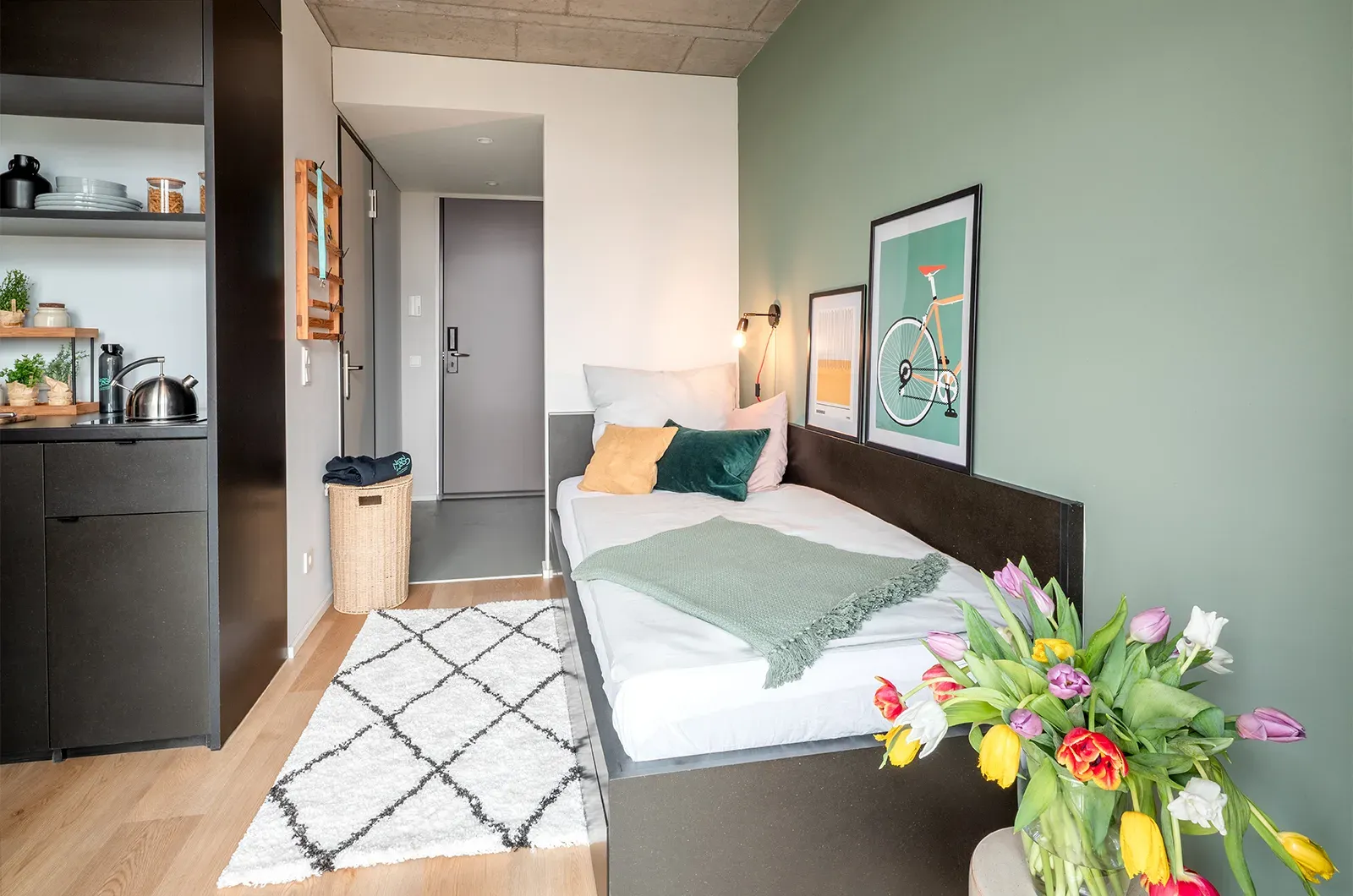 Styled bed and entrance area in a Classic Balcony Room at Neon Wood Berlin Mitte-Wedding showing decorated space and personalization example