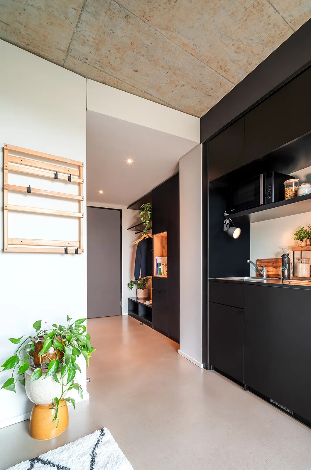 Styled entrance and kitchen area in a Classic Deluxe Room at Neon Wood Frankfurt Riedberg showing decorated space and personalization example